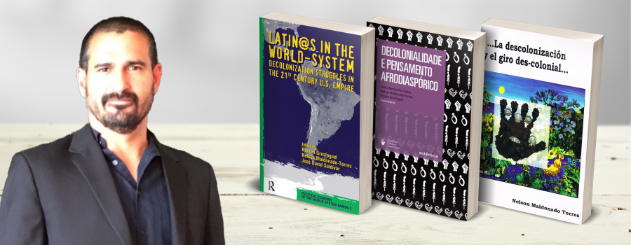 Professor Nelson Maldonado Torres with three books he has written. From left to right, "Latin@s in the World-System," "Decolonialidade e Pensamento Afrodiasporico," and "La descolonizacion y el giro des colonial..."